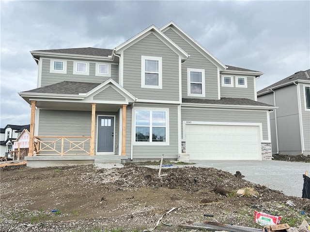 16965 S Mahaffie St, Olathe, KS 66062 - view of front facade with driveway, a porch, and a garage