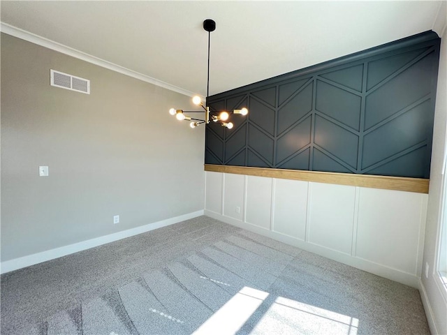16965 S Mahaffie St, Olathe, KS 66062 - empty room featuring a decorative wall, crown molding, carpet flooring, a chandelier, and baseboards