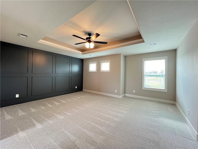 16965 S Mahaffie St, Olathe, KS 66062 - unfurnished bedroom with a raised ceiling, light carpet, baseboards, and ceiling fan