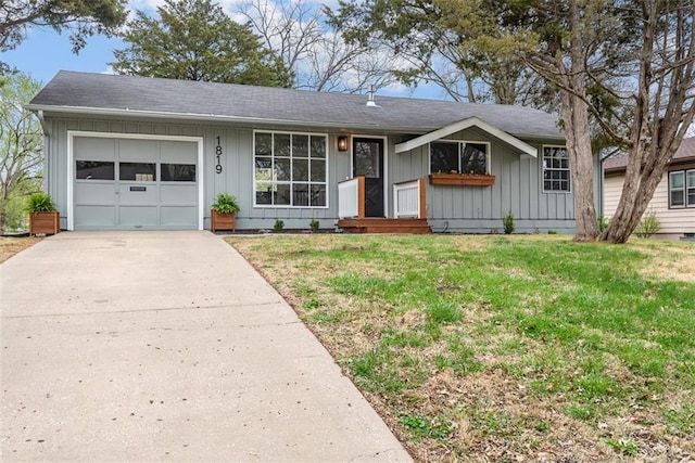 single story home with a front lawn, driveway, a garage, and board and batten siding