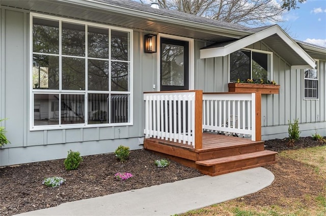 property entrance featuring board and batten siding and roof with shingles