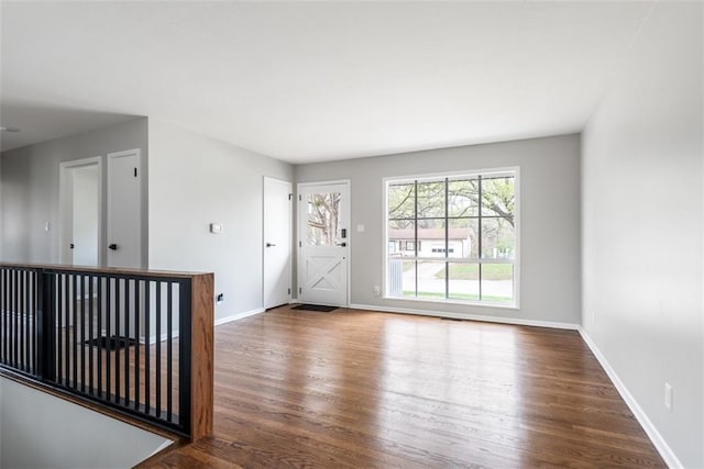empty room featuring baseboards and wood finished floors