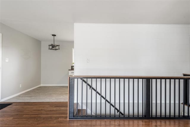 stairway featuring baseboards and wood finished floors