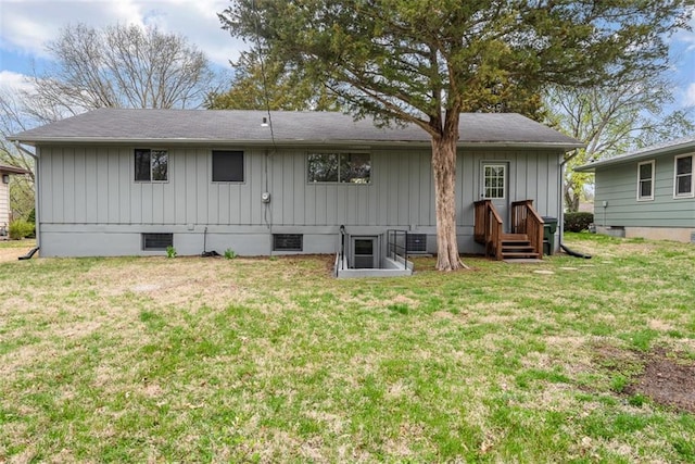 back of house with a lawn and board and batten siding