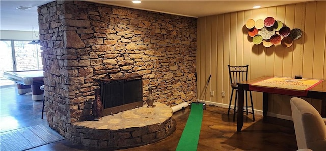 interior space featuring a fireplace, baseboards, and wood finished floors