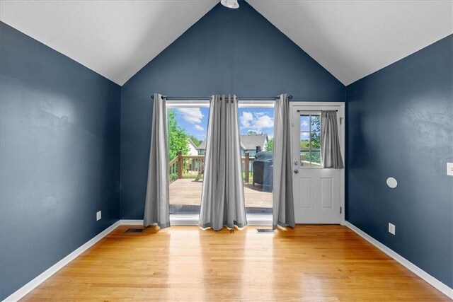 2357 SW Current Ct, Lees Summit, MO 64082 - doorway featuring a healthy amount of sunlight, baseboards, light wood finished floors, and lofted ceiling