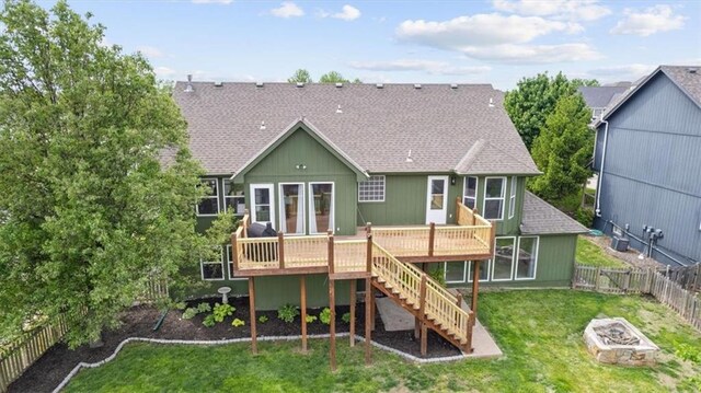 2357 SW Current Ct, Lees Summit, MO 64082 - rear view of property with a fire pit, a wooden deck, a fenced backyard, stairs, and a yard