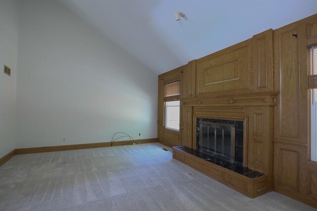 1313 NW 12th St, Blue Springs, MO 64015 - unfurnished living room with light colored carpet, a high end fireplace, baseboards, and high vaulted ceiling