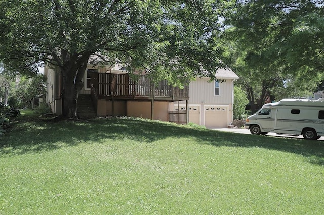 1313 NW 12th St, Blue Springs, MO 64015 - view of grassy yard with a garage, a wooden deck, and stairway