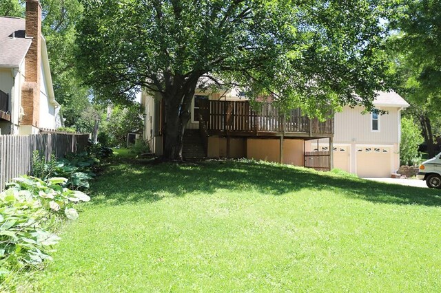 1313 NW 12th St, Blue Springs, MO 64015 - view of yard with an attached garage and a wooden deck