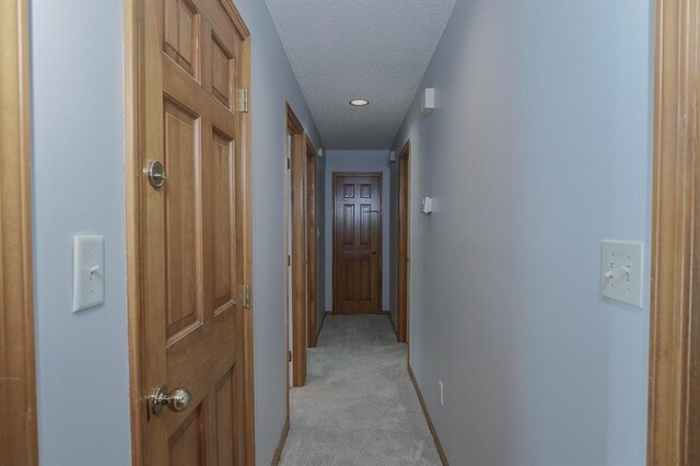 1313 NW 12th St, Blue Springs, MO 64015 - hallway with a textured ceiling, light carpet, baseboards, and recessed lighting