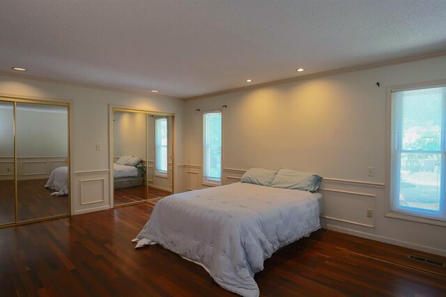 1313 NW 12th St, Blue Springs, MO 64015 - bedroom with multiple closets, wood finished floors, ornamental molding, multiple windows, and a wainscoted wall