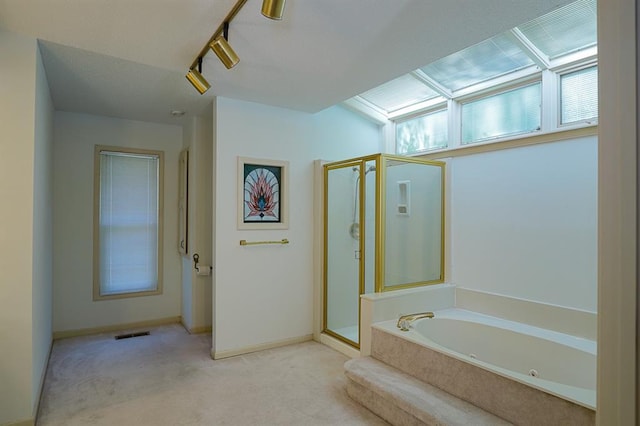 1313 NW 12th St, Blue Springs, MO 64015 - bathroom featuring a shower stall, a jetted tub, track lighting, and baseboards