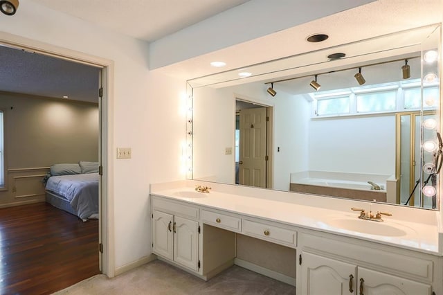 1313 NW 12th St, Blue Springs, MO 64015 - ensuite bathroom with double vanity, a garden tub, and rail lighting
