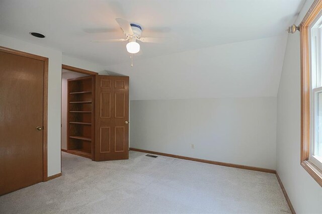 1313 NW 12th St, Blue Springs, MO 64015 - additional living space featuring lofted ceiling, light colored carpet, baseboards, and ceiling fan