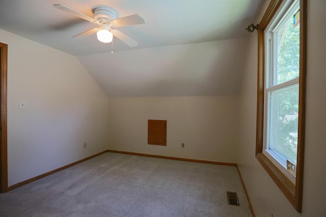 1313 NW 12th St, Blue Springs, MO 64015 - additional living space featuring light carpet, vaulted ceiling, baseboards, and a ceiling fan