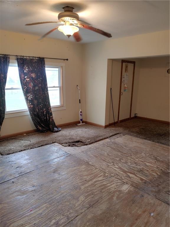 608 E Lake St, Mclouth, KS 66054 - spare room with a wealth of natural light, baseboards, and a ceiling fan