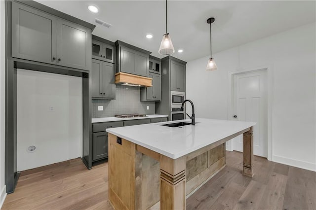 502 Seventh St, Smithville, MO 64089 - kitchen with a sink, stainless steel appliances, light wood-type flooring, tasteful backsplash, and recessed lighting