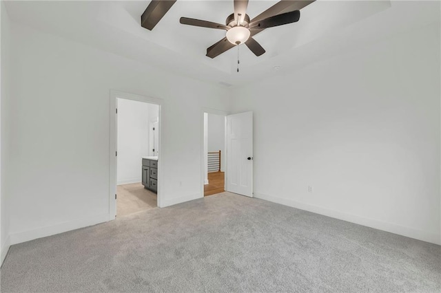502 Seventh St, Smithville, MO 64089 - unfurnished bedroom featuring light colored carpet, baseboards, a ceiling fan, and ensuite bathroom