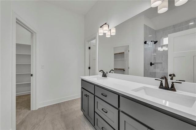 502 Seventh St, Smithville, MO 64089 - bathroom with walk in shower, a walk in closet, double vanity, marble finish flooring, and baseboards
