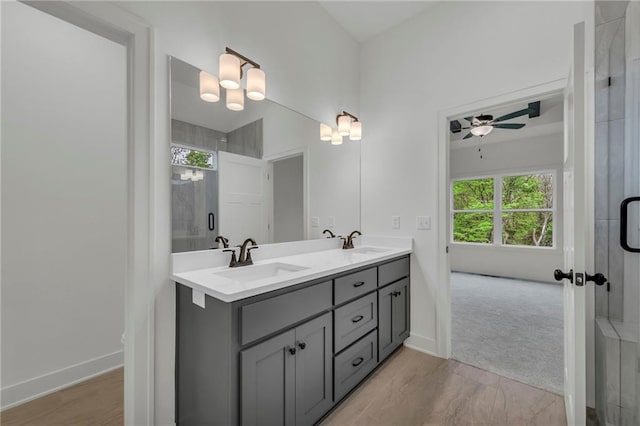 502 Seventh St, Smithville, MO 64089 - bathroom featuring a ceiling fan, double vanity, an enclosed shower, and baseboards