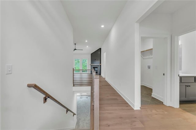 502 Seventh St, Smithville, MO 64089 - stairs with ceiling fan, wood finished floors, recessed lighting, baseboards, and a fireplace