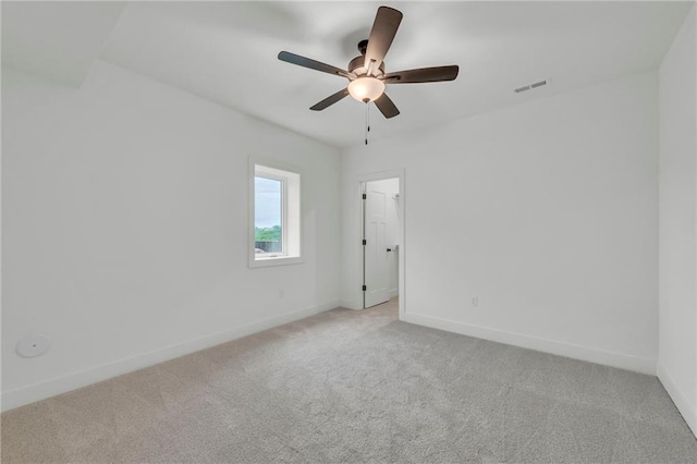 502 Seventh St, Smithville, MO 64089 - spare room with light carpet, baseboards, and ceiling fan