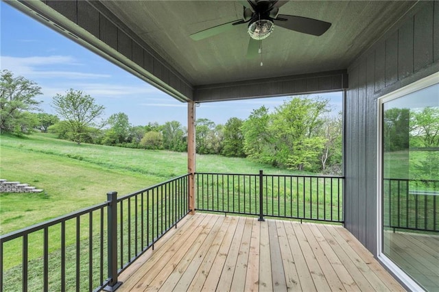 502 Seventh St, Smithville, MO 64089 - wooden deck with ceiling fan, a lawn, and view of scattered trees