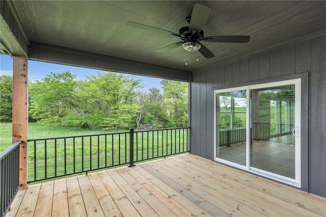 502 Seventh St, Smithville, MO 64089 - wooden deck with a ceiling fan, a yard, and view of wooded area