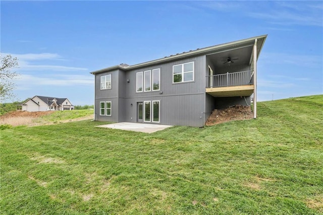 502 Seventh St, Smithville, MO 64089 - back of house with a ceiling fan, a patio area, and a lawn