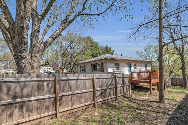 view of yard featuring a wooden deck and a fenced front yard