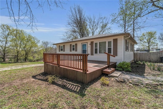 exterior space featuring a deck and fence