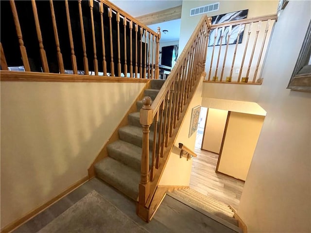 8200 Chas Cir, Pleasant Valley, MO 64068 - staircase featuring baseboards, visible vents, and wood finished floors