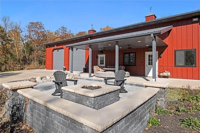 33345 W 95th St, De Soto, KS 66018 - view of patio with a fire pit, ceiling fan, and a garage