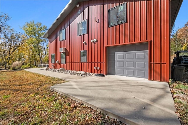 33345 W 95th St, De Soto, KS 66018 - view of home's exterior with concrete driveway, board and batten siding, and a garage