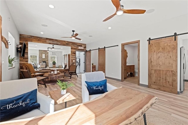33345 W 95th St, De Soto, KS 66018 - living area featuring a barn door, a ceiling fan, recessed lighting, light wood-style flooring, and baseboards