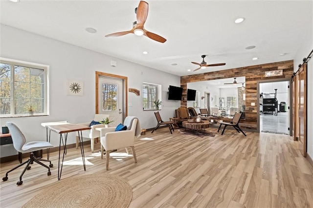 33345 W 95th St, De Soto, KS 66018 - living room with plenty of natural light, light wood-style flooring, a ceiling fan, recessed lighting, and wooden walls