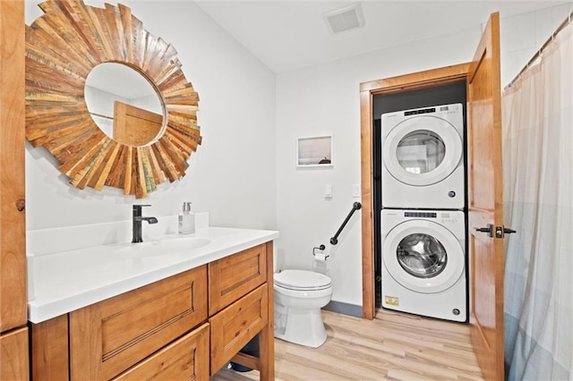 33345 W 95th St, De Soto, KS 66018 - bathroom featuring stacked washer / dryer, toilet, wood finished floors, and vanity