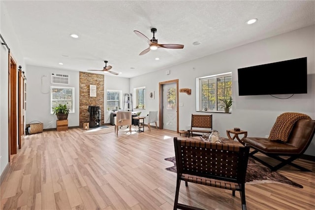 33345 W 95th St, De Soto, KS 66018 - living area with a barn door, recessed lighting, light wood finished floors, ceiling fan, and baseboards