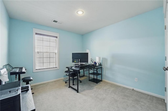 office area with baseboards, light colored carpet, and visible vents
