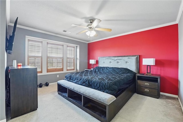 carpeted bedroom featuring crown molding, baseboards, and visible vents