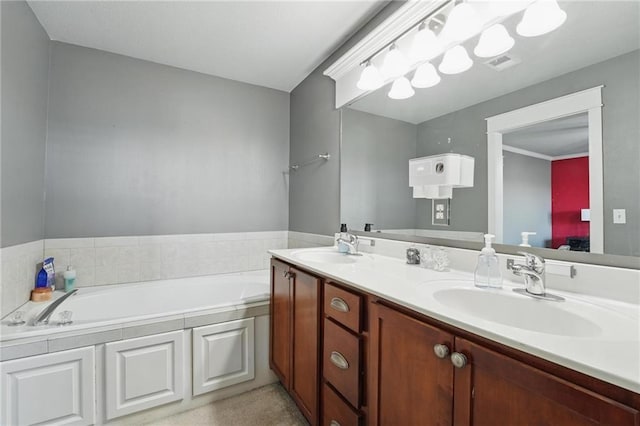 full bathroom with a sink, a bath, double vanity, and visible vents