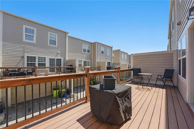 wooden terrace featuring outdoor dining area and a residential view
