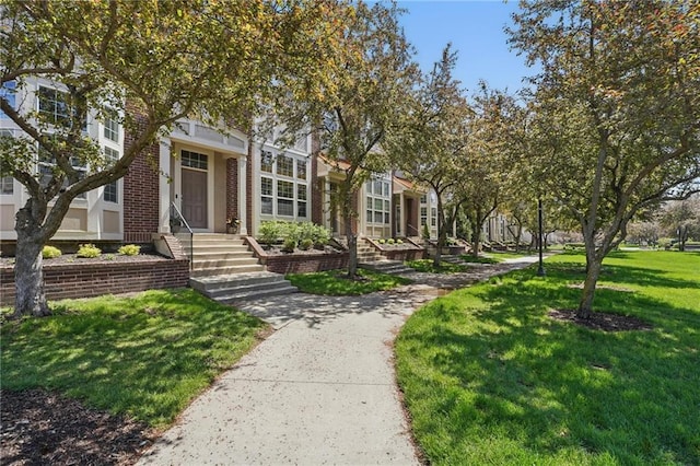 view of front of property with brick siding and a front lawn