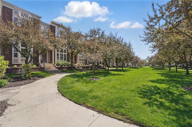 view of property's community with a lawn