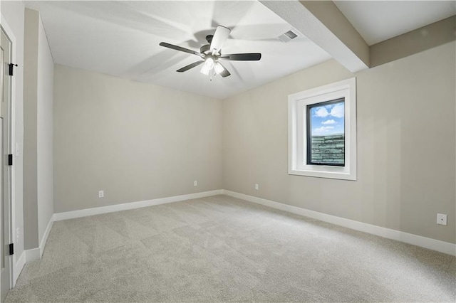 unfurnished room featuring light colored carpet, a ceiling fan, and baseboards