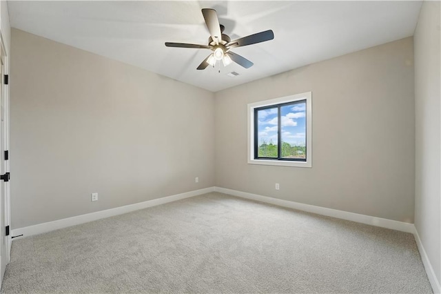 unfurnished room featuring light colored carpet, baseboards, and ceiling fan