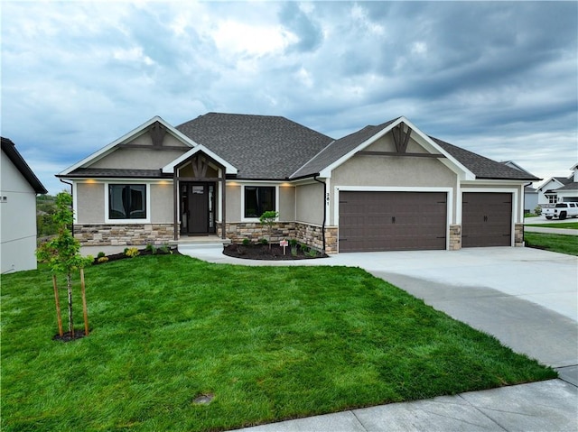 craftsman-style home featuring a garage, stucco siding, a front lawn, concrete driveway, and stone siding