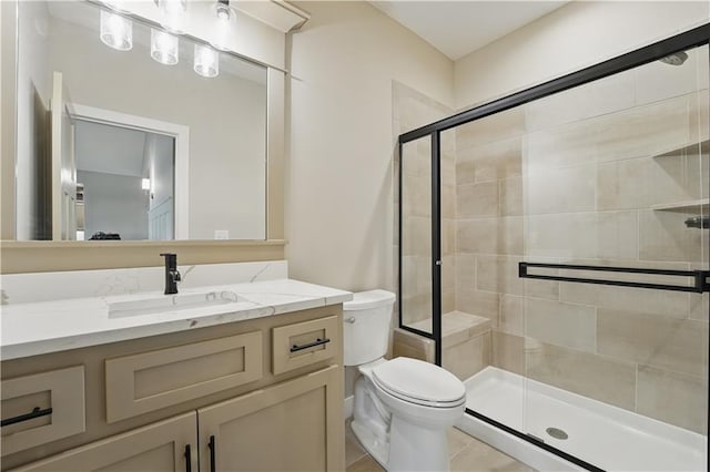 full bathroom with a shower stall, toilet, vanity, and tile patterned flooring