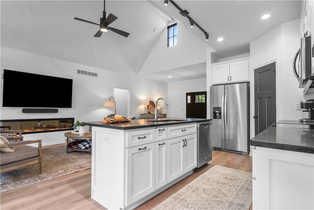38 Lakeview Ln, Linn Valley, KS 66040 - kitchen featuring appliances with stainless steel finishes, open floor plan, light wood-type flooring, a ceiling fan, and high vaulted ceiling